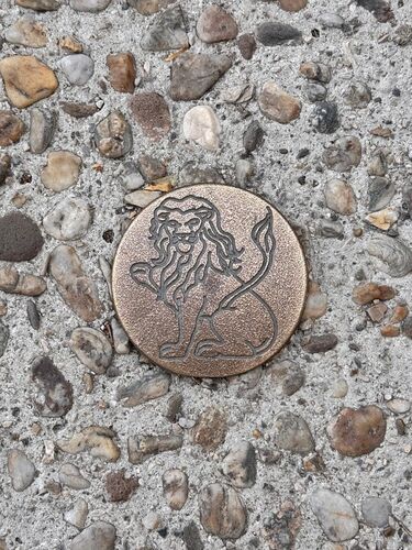 Brass plate embedded in sidewalk. The symbol of Arles(Arelate), showing loyalty to Caesar’s Sixth Legion